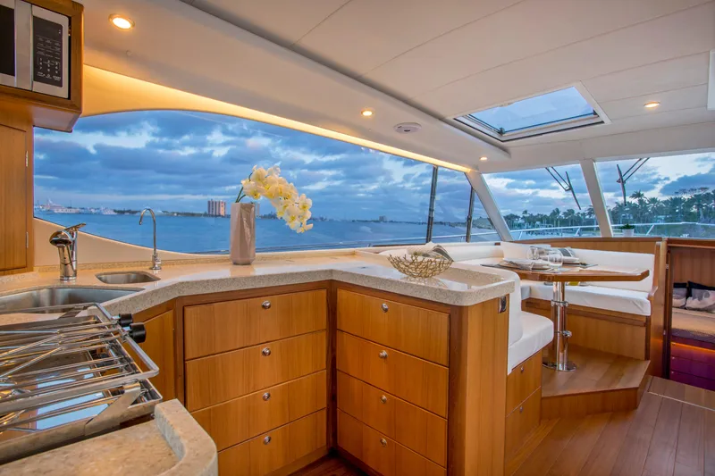 Slide: The Image of Luxurious interior of 2025 Hylas M49 yacht with ocean view and elegant dining area. - 13