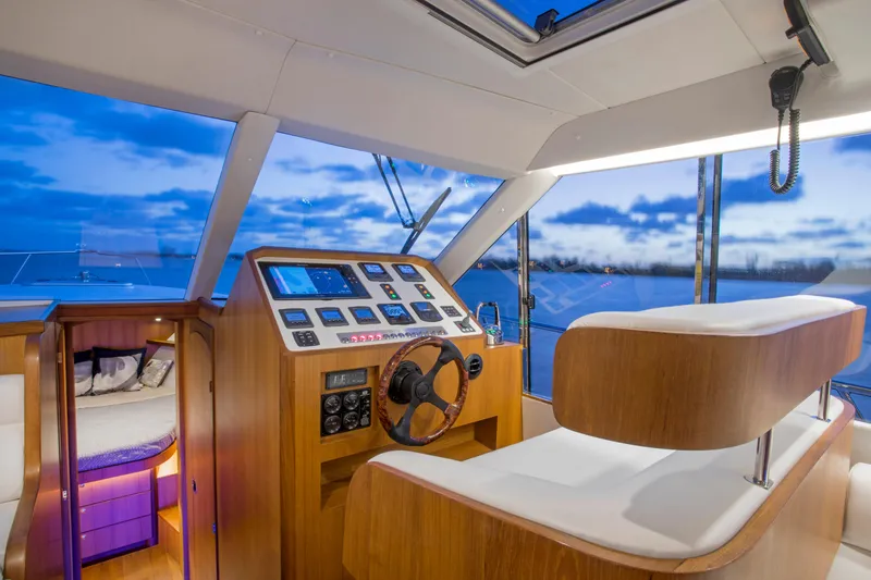 Slide: The Image of Luxurious 2025 Hylas M49 yacht interior with modern helm and panoramic windows at sunset. - 14