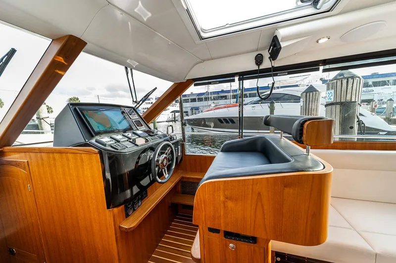 Slide: The Image of Manufacturer Provided Image: Interior of 2025 Hylas M49 yacht with modern helm and luxurious wood finish. - 15