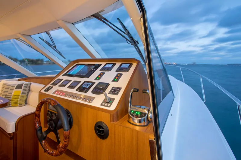 Slide: The Image of Helm of 2025 Hylas M49 yacht with modern navigation controls at sea. - 2