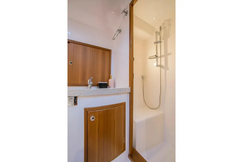 Slide: The Image of Luxurious bathroom in 2025 Hylas M49 yacht with modern shower and wooden cabinetry. - 21