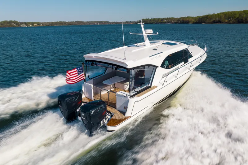 Slide: The Image of 2025 Hylas M49 yacht cruising on a lake with American flag. - 22