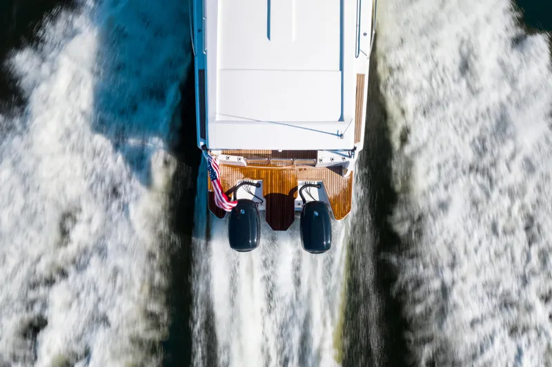 Slide: The Image of Aerial view of 2025 Hylas M49 boat cruising with twin engines and American flag. - 23