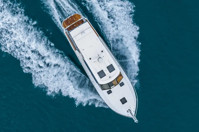 Slide: The Image of Manufacturer Provided Image: Aerial view of 2025 Hylas M49 yacht cruising on blue ocean waters. - 6