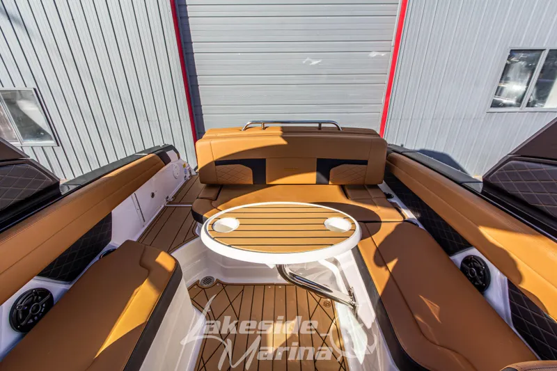 Slide: The Image of 2026 Chaparral SSX 6 boat interior with tan seating and round table. - 17