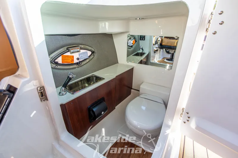 Slide: The Image of 2026 Chaparral SSX 6 boat interior bathroom with sink, toilet, and mirror. - 26