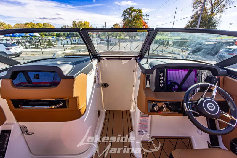 Slide: The Image of 2026 Chaparral SSX 6 boat cockpit with modern dashboard and steering wheel at Lakeside Marina. - 27
