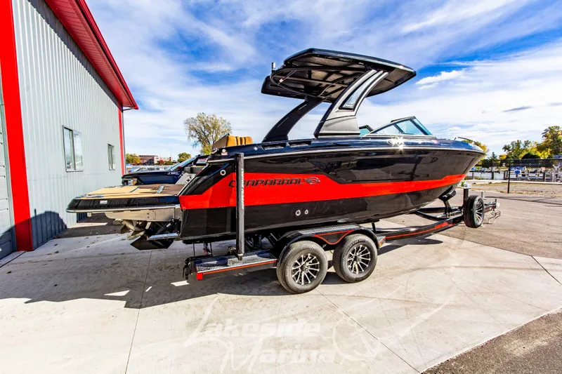 Slide: The Image of 2026 Chaparral SSX 6 boat on trailer, black and red design, parked outdoors. - 3