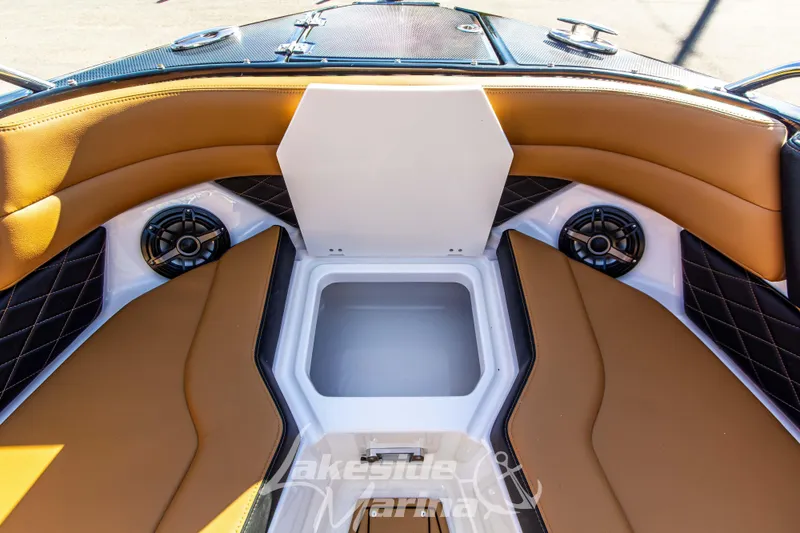 Slide: The Image of 2026 Chaparral SSX 6 boat interior with tan seating, storage compartment, and speakers. - 35