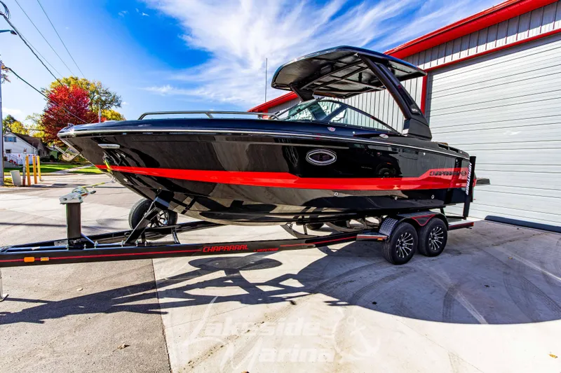 Slide: The Image of 2026 Chaparral SSX 6 boat on trailer, black with red accents, parked outdoors. - 8