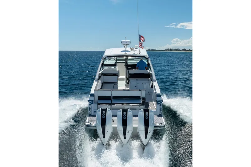 Slide: The Image of 2026 Monterey 385SS Super Sport boat cruising on open water, rear view. - 3