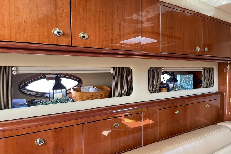 Slide: The Image of Luxurious 2003 Sea Ray 550 Sundancer interior with polished wood cabinets and decorative accents. - 17