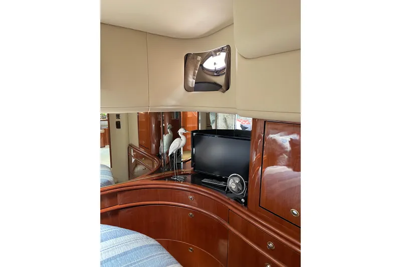 Slide: The Image of Interior of 2003 Sea Ray 550 Sundancer yacht with TV and elegant wood cabinetry. - 18