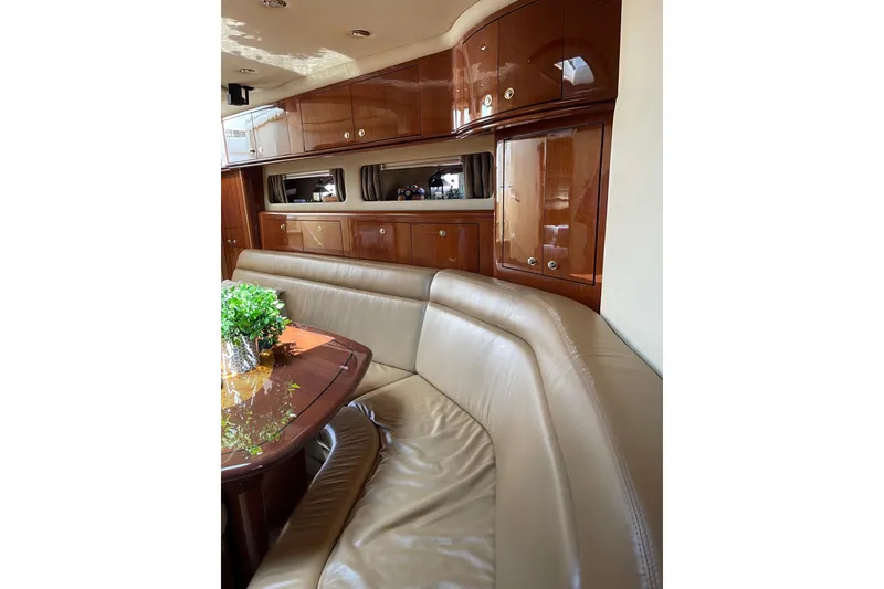Slide: The Image of Luxurious interior of 2003 Sea Ray 550 Sundancer yacht with leather seating and wooden cabinetry. - 19