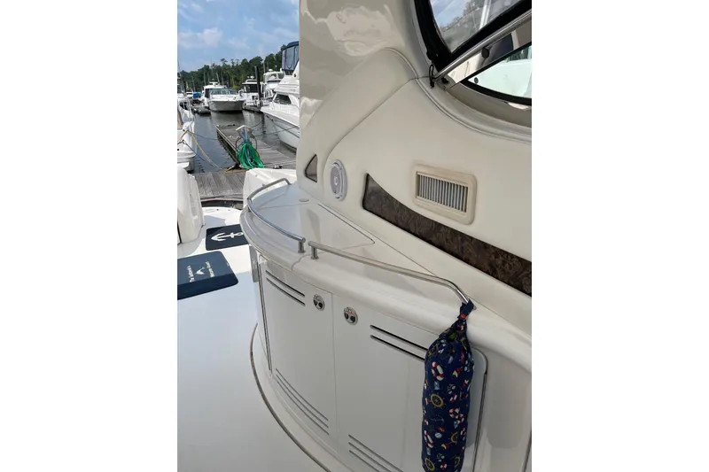 Slide: The Image of 2003 Sea Ray 550 Sundancer yacht interior with storage and marina view. - 2