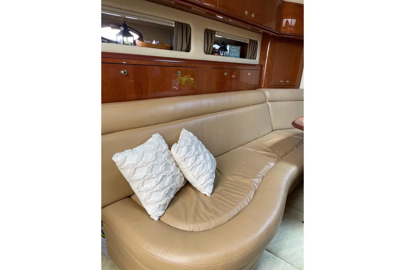 Slide: The Image of Luxurious interior of 2003 Sea Ray 550 Sundancer with leather seating and decorative pillows. - 20