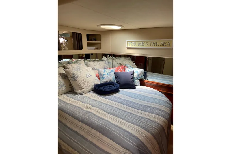 Slide: The Image of Cozy bedroom in 2003 Sea Ray 550 Sundancer yacht with nautical decor. - 26