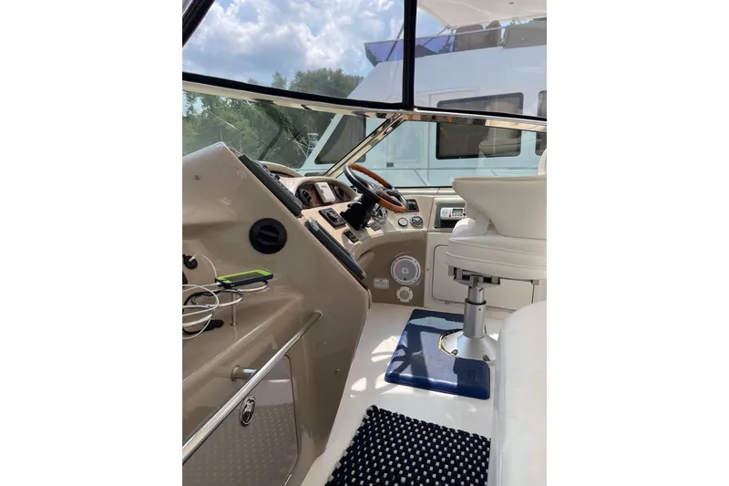 Slide: The Image of 2003 Sea Ray 550 Sundancer helm with modern controls and comfortable seating. - 3