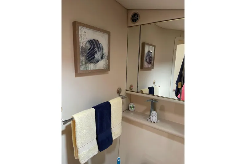 Slide: The Image of Bathroom interior of 2003 Sea Ray 550 Sundancer with nautical decor and towels. - 31
