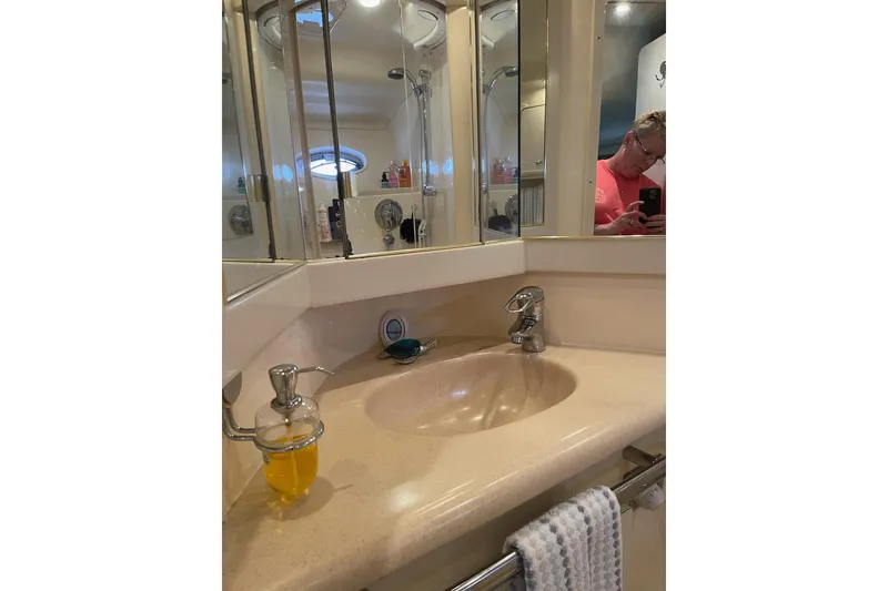 Slide: The Image of Bathroom vanity in 2003 Sea Ray 550 Sundancer yacht with mirror and sink. - 32