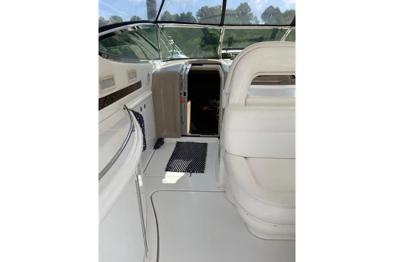 Slide: The Image of 2003 Sea Ray 550 Sundancer interior with white seating and cabin entrance. - 6