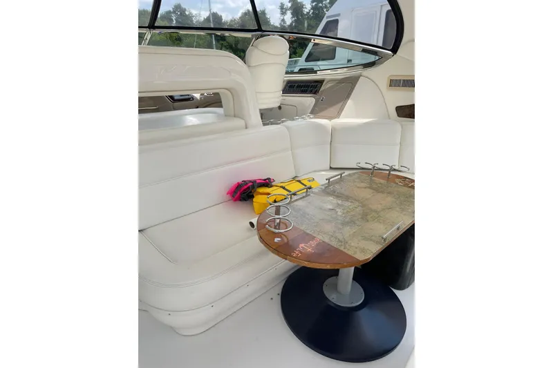 Slide: The Image of Luxurious interior of 2003 Sea Ray 550 Sundancer yacht with white seating and map table. - 7