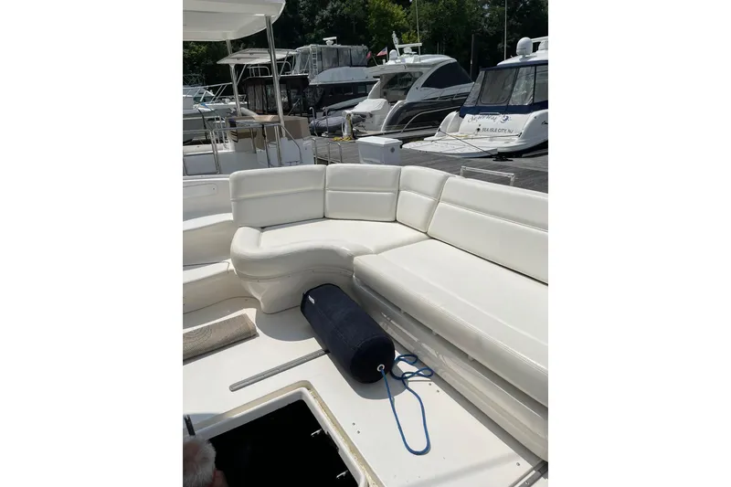 Slide: The Image of 2003 Sea Ray 550 Sundancer yacht with white leather seating at a marina. - 8