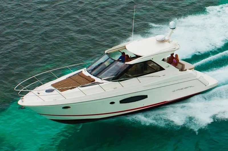 Slide: The Image of Manufacturer Provided Image: 2013 Regal 42 Sport Coupe cruising on clear blue water. - 1