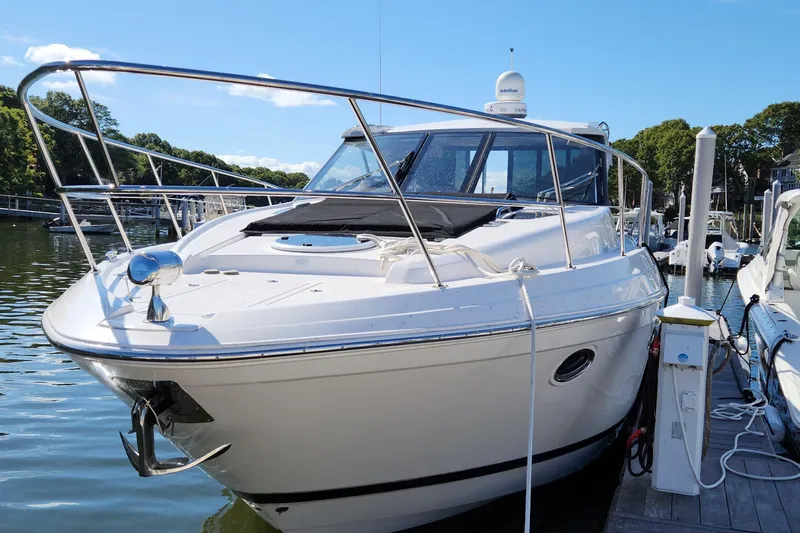 Slide: The Image of 2013 Regal 42 Sport Coupe yacht docked at marina, sunny day, calm waters. - 13