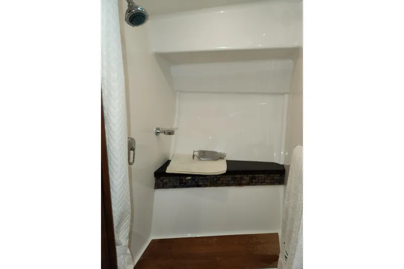 Slide: The Image of Shower area in 2013 Regal 42 Sport Coupe yacht, featuring modern fixtures and sleek design. - 18