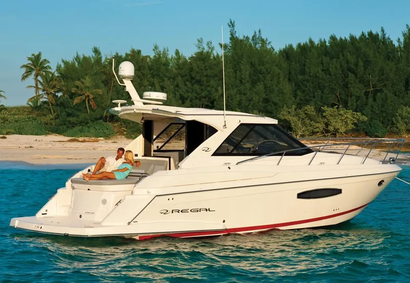 Slide: The Image of Manufacturer Provided Image: 2013 Regal 42 Sport Coupe yacht cruising near a tropical beach. - 2