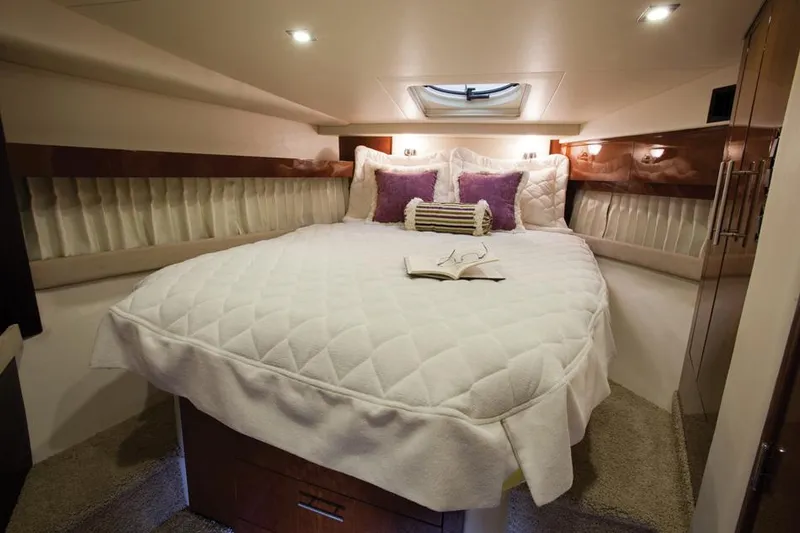 Slide: The Image of Manufacturer Provided Image: Luxurious bedroom in 2013 Regal 42 Sport Coupe yacht with plush bedding and ambient lighting. - 7