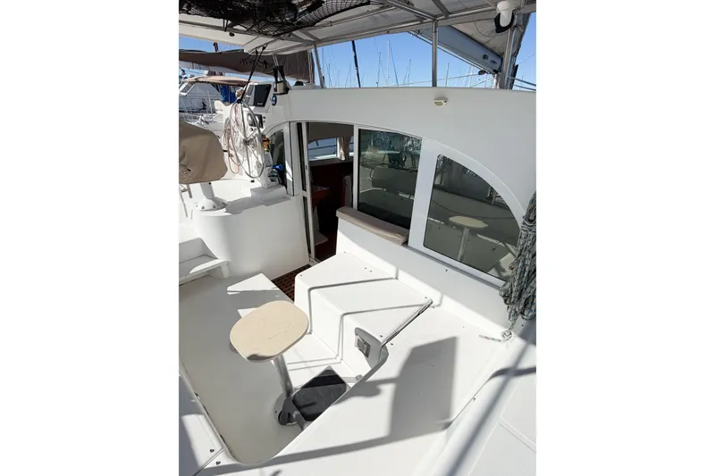 Slide: The Image of 2005 Lagoon 380 S2 catamaran cockpit with seating and helm station. - 19
