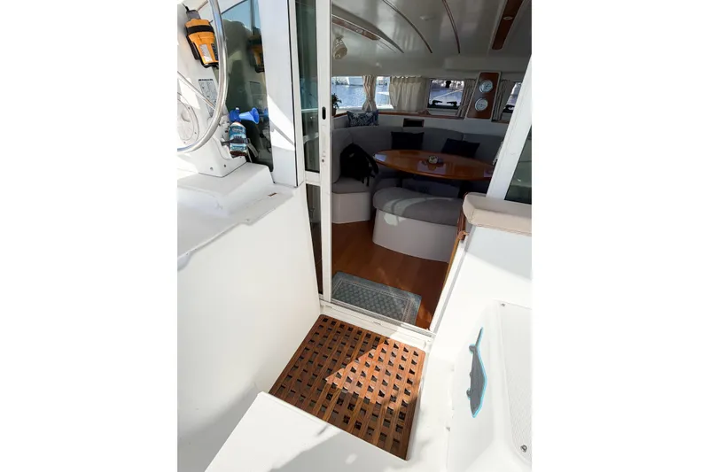 Slide: The Image of Interior view of 2005 Lagoon 380 S2 catamaran, featuring cozy seating and wooden flooring. - 20
