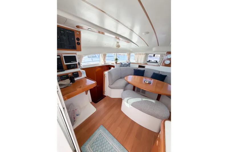 Slide: The Image of Interior of 2005 Lagoon 380 S2 catamaran with cozy seating and navigation equipment. - 21
