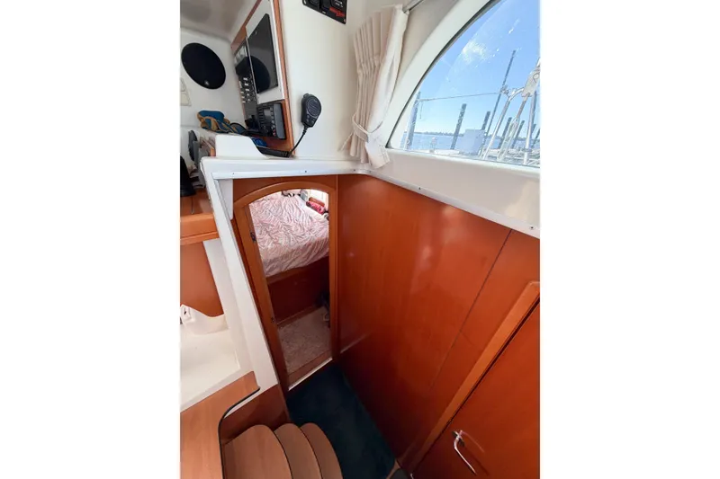 Slide: The Image of Interior of 2005 Lagoon 380 S2 catamaran with wood paneling and cabin view. - 29