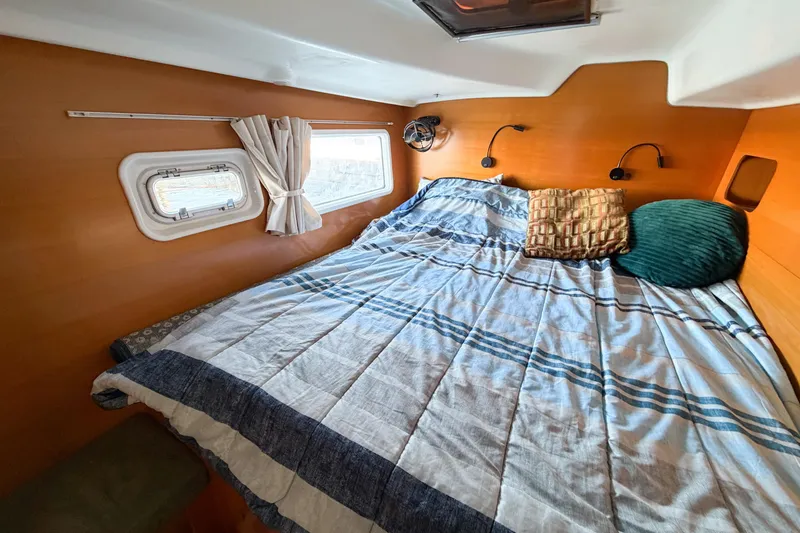 Slide: The Image of Cozy cabin interior of 2005 Lagoon 380 S2 catamaran with bed and porthole. - 36