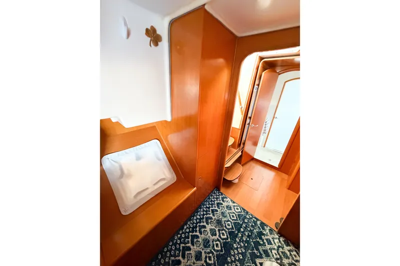 Slide: The Image of Interior of 2005 Lagoon 380 S2 yacht with wooden finish and patterned carpet. - 39