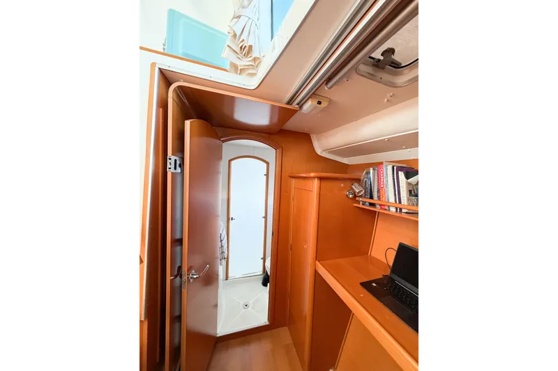 Slide: The Image of Interior of 2005 Lagoon 380 S2 yacht with wooden cabinetry and bookshelves. - 40