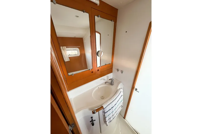 Slide: The Image of Bathroom interior of 2005 Lagoon 380 S2 yacht with sink and mirror. - 42