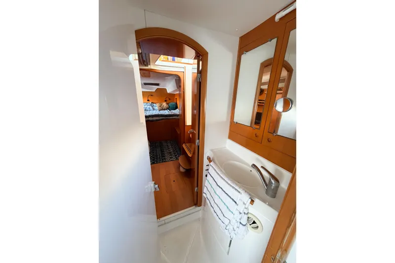 Slide: The Image of Interior of 2005 Lagoon 380 S2 yacht showing bathroom and cabin area. - 47