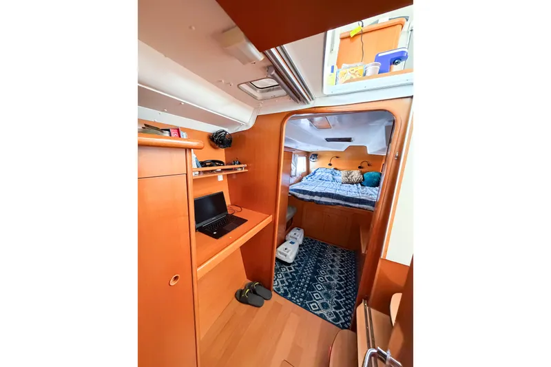 Slide: The Image of Interior of 2005 Lagoon 380 S2 catamaran with cozy cabin and workspace. - 49