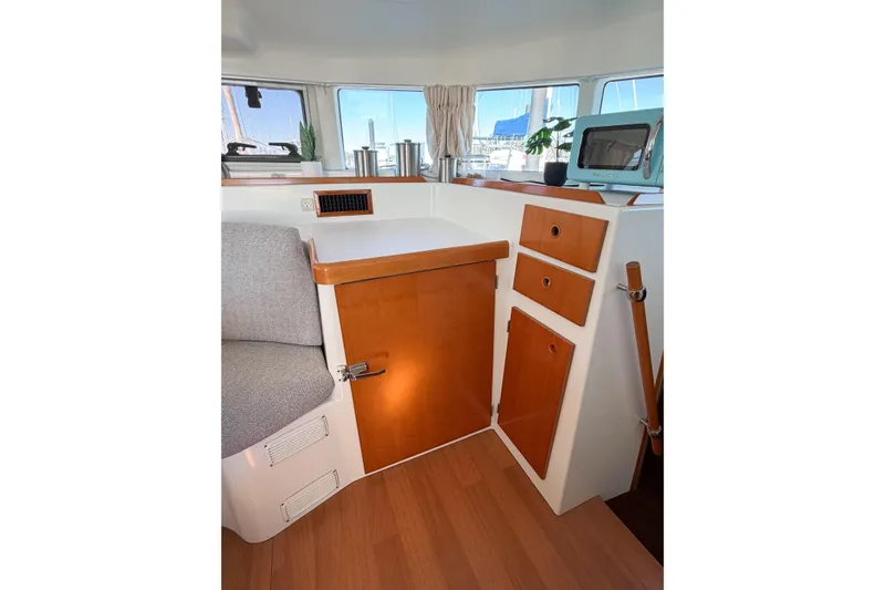 Slide: The Image of Interior of 2005 Lagoon 380 S2 yacht with wooden cabinetry and seating area. - 52