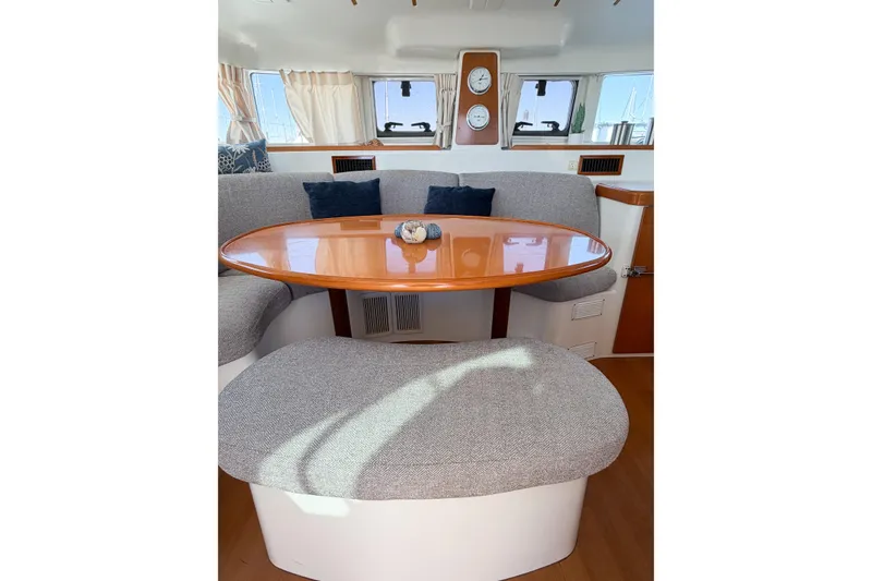 Slide: The Image of Interior of 2005 Lagoon 380 S2 catamaran with cozy seating and wooden table. - 54