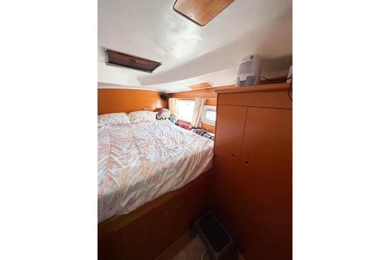 Slide: The Image of Cozy cabin interior of 2005 Lagoon 380 S2 catamaran with bed and storage. - 60