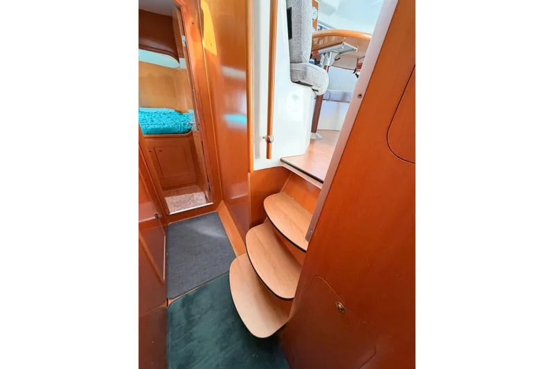 Slide: The Image of Interior of 2005 Lagoon 380 S2 catamaran with wooden steps and cozy cabin. - 63