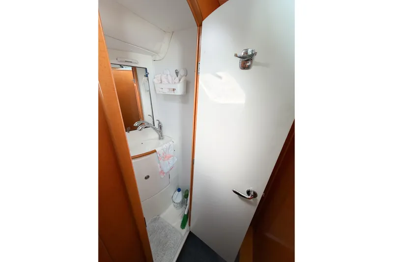 Slide: The Image of Compact bathroom in 2005 Lagoon 380 S2 yacht, featuring sink and storage. - 64