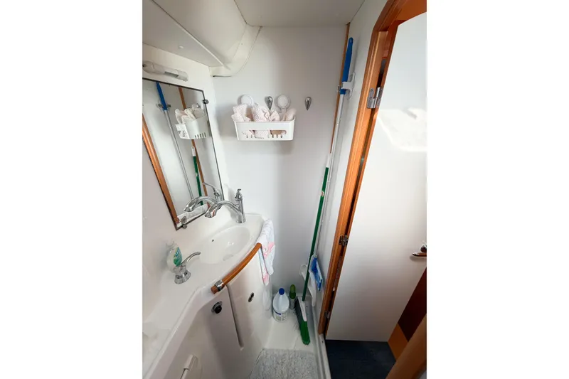 Slide: The Image of Compact bathroom in a 2005 Lagoon 380 S2 yacht with sink and cleaning supplies. - 65