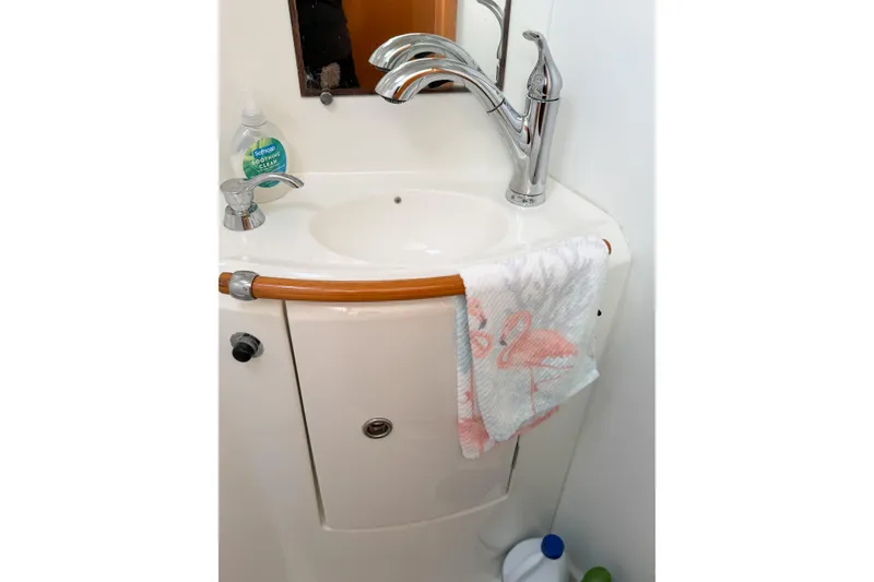 Slide: The Image of Bathroom sink area in 2005 Lagoon 380 S2 yacht with towel and soap. - 68