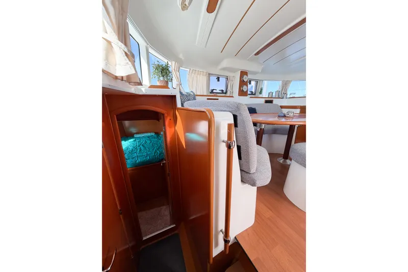 Slide: The Image of Interior of 2005 Lagoon 380 S2 catamaran with cozy seating and wooden finishes. - 71